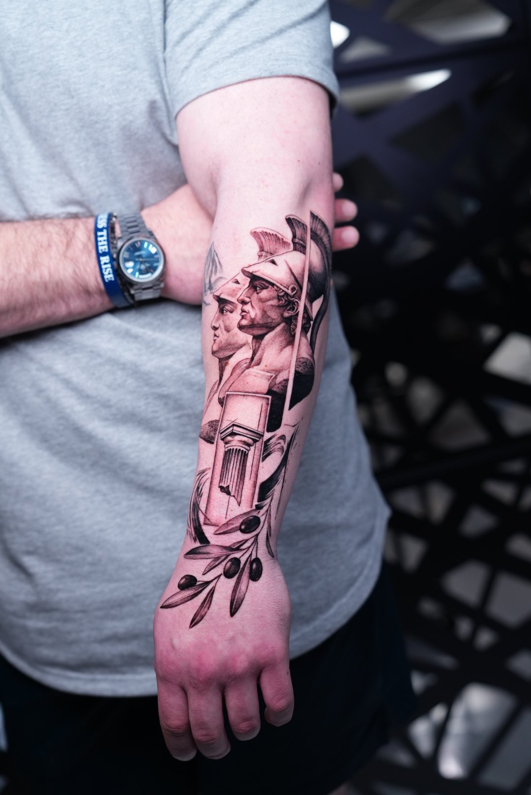 Greek mythology Achilles bust with olive branch and column — black and grey realism forearm tattoo